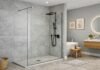 Fixed glass shower panel in modern UK bathroom showing frameless shower screen design